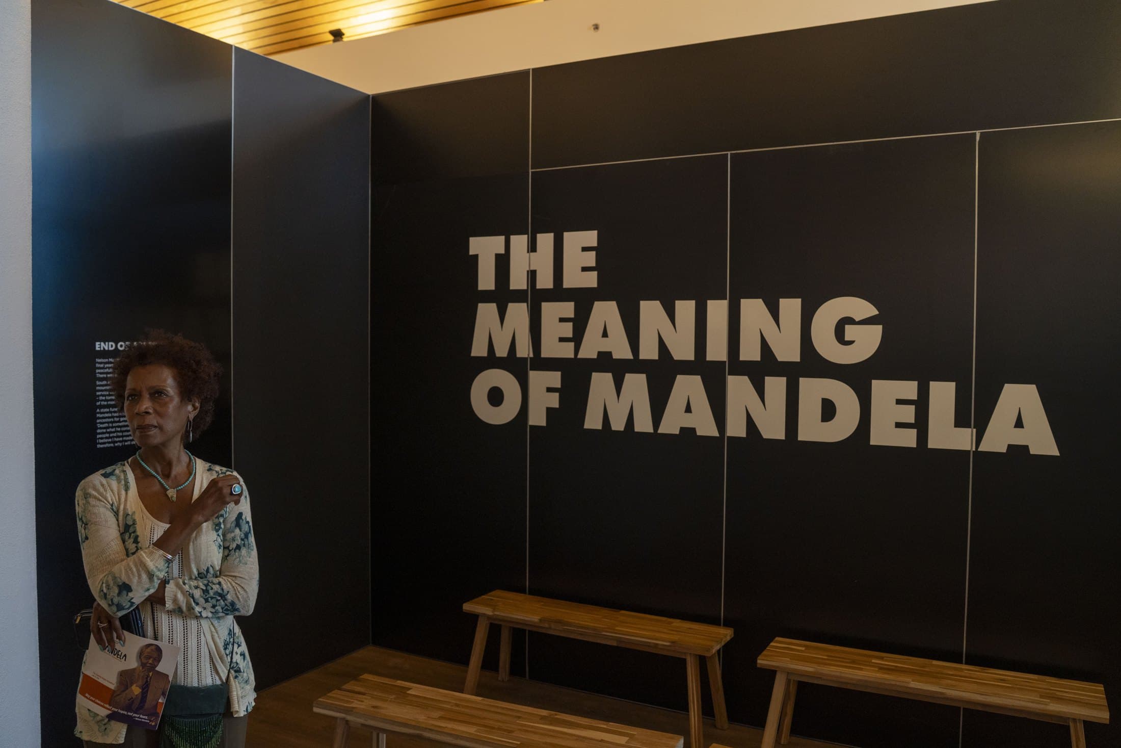 A visitor in the "Meaning of Mandela" gallery of Mandela: The Official Exhibition at the African American Museum, Dallas. Photo by Lawrence Jenkins, courtesy of the African American Museum, Dallas