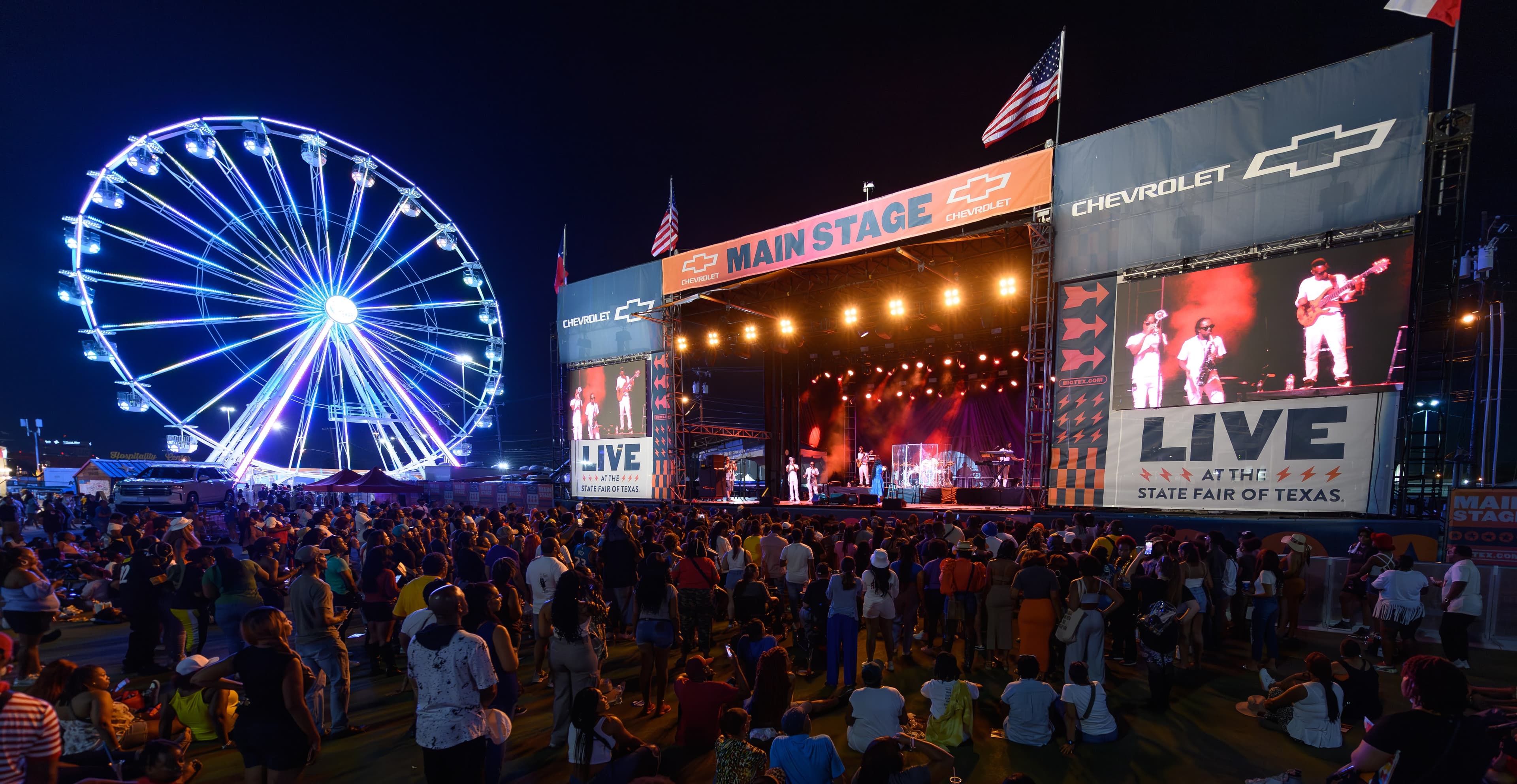File photo: The former outdoor Chevrolet Main Stage and a Ferris wheel are illuminated during a 2023 concert.
